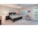 Bright bedroom with shuttered windows, ceiling fan, and a cozy chair, offering a serene retreat at 8335 Lake Burden Circle, Windermere, FL 34786