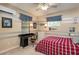 Cozy bedroom featuring a desk, striped walls, and a ceiling fan, perfect for studying and relaxation at 8335 Lake Burden Circle, Windermere, FL 34786