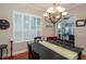 Elegant dining room with modern lighting, window shutters, and an open view to the outdoor patio at 8335 Lake Burden Circle, Windermere, FL 34786