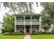 Charming two-story home with inviting front porch, lush landscaping, and a well-manicured lawn at 8335 Lake Burden Circle, Windermere, FL 34786