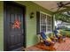 Charming front porch with rocking chairs, festive decorations, and a welcoming entrance to the home at 8335 Lake Burden Circle, Windermere, FL 34786