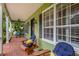 Relaxing front porch area showcasing comfortable seating, beautiful plants, and a welcoming entrance at 8335 Lake Burden Circle, Windermere, FL 34786