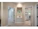 Hallway with laundry room access, featuring neutral tones and a display niche, offers practical elegance at 8335 Lake Burden Circle, Windermere, FL 34786