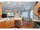 Open kitchen showcasing wood cabinets, stainless appliances, and flowing access to adjacent living and dining areas at 8335 Lake Burden Circle, Windermere, FL 34786