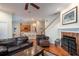 Open-concept living room with hardwood floors, fireplace, and seamless flow to the kitchen and dining areas at 8335 Lake Burden Circle, Windermere, FL 34786