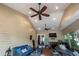 Cozy screened room with comfortable seating, fireplace, and television at 8335 Lake Burden Circle, Windermere, FL 34786