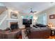 Inviting living room with a fireplace, hardwood floors, and comfortable leather furniture at 8335 Lake Burden Circle, Windermere, FL 34786