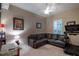 Comfortable living room featuring a leather sectional, treadmill and ample natural light at 8335 Lake Burden Circle, Windermere, FL 34786