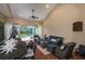 Relaxing screened-in patio with stylish furnishings and a view of the beautiful backyard pool at 8335 Lake Burden Circle, Windermere, FL 34786
