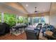 Beautiful screened-in patio offering a comfortable seating area and dining space by the pool at 8335 Lake Burden Circle, Windermere, FL 34786