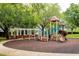 Community playground featuring slides, swings, and a covered picnic area amidst mature trees at 8335 Lake Burden Circle, Windermere, FL 34786
