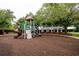 Community playground featuring slides, swings, and a covered picnic area amidst mature trees at 8335 Lake Burden Circle, Windermere, FL 34786