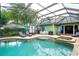 Inviting screened-in pool with a spa, lounge chairs, and ample space for outdoor relaxation at 8335 Lake Burden Circle, Windermere, FL 34786