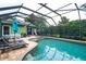Inviting screened pool area with spa, lounge chairs, and outdoor dining space at 8335 Lake Burden Circle, Windermere, FL 34786