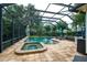 Screened-in pool area, complete with a spa, sun loungers and seating for relaxation and entertainment at 8335 Lake Burden Circle, Windermere, FL 34786