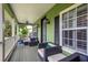 Inviting porch with comfortable seating, ceiling fan, and lush green surroundings, perfect for relaxing at 8335 Lake Burden Circle, Windermere, FL 34786