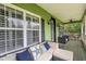 Charming porch featuring comfortable seating, stylish decor, and a welcoming outdoor space at 8335 Lake Burden Circle, Windermere, FL 34786