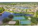 Expansive aerial view of a community featuring a lake, tennis courts, basketball court, sand volleyball court and playground at 848 Magnolia Creek Cir, Orlando, FL 32828