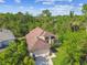 An aerial view showing the home nestled among lush trees with a large driveway at 848 Magnolia Creek Cir, Orlando, FL 32828