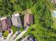 Bird's eye view showcases the house among lush greenery, next to the solar panels and a pool at 848 Magnolia Creek Cir, Orlando, FL 32828