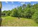 The backyard boasts ample lawn space and features established landscaping with a fire pit at 848 Magnolia Creek Cir, Orlando, FL 32828