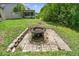 A charming fire pit in the backyard with stone surround, perfect for outdoor relaxation at 848 Magnolia Creek Cir, Orlando, FL 32828