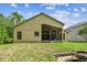A view of the backyard that shows the screened in patio and fire pit at 848 Magnolia Creek Cir, Orlando, FL 32828