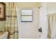 Clean white bathroom with shower and tub combination with window, and tile walls at 848 Magnolia Creek Cir, Orlando, FL 32828