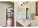 Bathroom featuring single sink vanity, framed mirror, decorative lighting, and neutral paint at 848 Magnolia Creek Cir, Orlando, FL 32828
