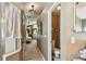 Bathroom hallway view leading to a bedroom and an adjacent toilet room at 848 Magnolia Creek Cir, Orlando, FL 32828