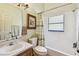 Bathroom with shower-tub combination, single sink vanity, framed art and window at 848 Magnolia Creek Cir, Orlando, FL 32828