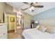 Relaxing bedroom featuring a ceiling fan, and access to a modern bathroom at 848 Magnolia Creek Cir, Orlando, FL 32828