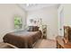 Cozy bedroom with neutral walls, plush carpet, and window with lush green views at 848 Magnolia Creek Cir, Orlando, FL 32828