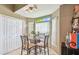 Breakfast nook features tile floor, a glass table and light filled windows at 848 Magnolia Creek Cir, Orlando, FL 32828