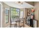 Cozy breakfast nook with glass table, beverage cooler, and large windows at 848 Magnolia Creek Cir, Orlando, FL 32828