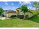 Attractive single-story home with a green lawn, shrubbery, and a side-entry two-car garage at 848 Magnolia Creek Cir, Orlando, FL 32828