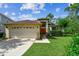 Charming single-story home with a two-car garage, red front door, and well-manicured lawn at 848 Magnolia Creek Cir, Orlando, FL 32828