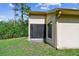 Back exterior view featuring the light beige stucco and a screened-in porch for outdoor enjoyment at 848 Magnolia Creek Cir, Orlando, FL 32828