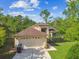 Beautiful front exterior with a two-car garage, well-maintained lawn, and mature trees at 848 Magnolia Creek Cir, Orlando, FL 32828