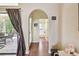 Hallway with wood floors leads from the lanai to a bathroom, with an arched entryway at 848 Magnolia Creek Cir, Orlando, FL 32828