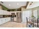 Bright kitchen with white cabinets, stainless steel appliances, and tile flooring at 848 Magnolia Creek Cir, Orlando, FL 32828