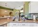 Open kitchen with stainless steel appliances, double sink, and green accent wall at 848 Magnolia Creek Cir, Orlando, FL 32828