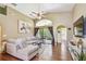 Bright living room features vaulted ceiling, wood floors, large sectional, and access to a screened patio at 848 Magnolia Creek Cir, Orlando, FL 32828