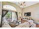 Bright living room with high ceilings, fan, wood floors, and sliding glass doors to the lanai at 848 Magnolia Creek Cir, Orlando, FL 32828