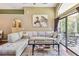 Spacious living room with hardwood floors, high ceilings, zebra art and access to the lanai at 848 Magnolia Creek Cir, Orlando, FL 32828