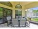 Screened-in patio featuring a tile floor, ceiling fan, and table set for outdoor dining at 848 Magnolia Creek Cir, Orlando, FL 32828