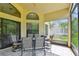 Screened-in patio featuring a tile floor, ceiling fan, and table set for outdoor dining at 848 Magnolia Creek Cir, Orlando, FL 32828