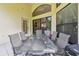 Screened-in patio featuring a tile floor, ceiling fan, and table set for outdoor dining at 848 Magnolia Creek Cir, Orlando, FL 32828