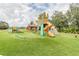 Well-maintained playground featuring slides, climbing structures, and a soft, artificial turf surface at 848 Magnolia Creek Cir, Orlando, FL 32828