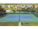 Enjoy a match on the community tennis court with scenic pond views and surrounding homes at 848 Magnolia Creek Cir, Orlando, FL 32828